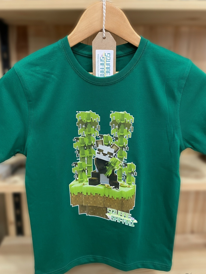 Green t-shirt with pixelated design of a character on a hanger Pixel art Giant Panda kids t-shirt in green — Square Safari original wildlife design, sizes 2–14. various colours including black, white, navy, grey kids t shirt with original artwork pixel design panda handmade in australia with worldwide shipping, gift for pixel and block style art lover perfect kids gift, animal lover gift idea