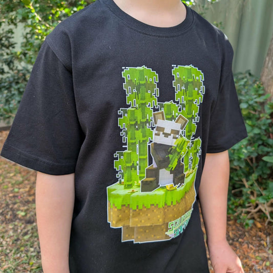 Child wearing a black t-shirt with a pixelated design of a panda in the rainforest