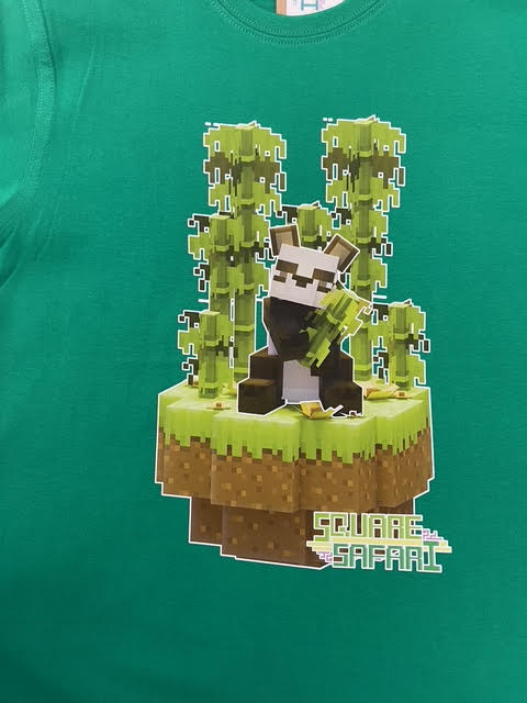 Green t-shirt with pixelated design of a character on a hanger Pixel art Giant Panda kids t-shirt in green — Square Safari original wildlife design, sizes 2–14. various colours including black, white, navy, grey kids t shirt with original artwork pixel design panda handmade in australia with worldwide shipping, gift for pixel and block style art lover perfect kids gift, animal lover gift idea